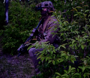 A special warfare team member assigned to the 57th Rescue Squadron sets an ambush while simulating the role of opposing force during exercise Astral Knight 24 in Gdynia, Poland, May 18, 2024. AK24 is a multinational exercise with allies and partners demonstrating and strengthening the Alliance’s shared commitment to global security and stability in the region. (U.S. Air Force photo by Capt. Jacob Murray)