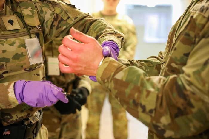 Military police officer put handcuffs on a military person
