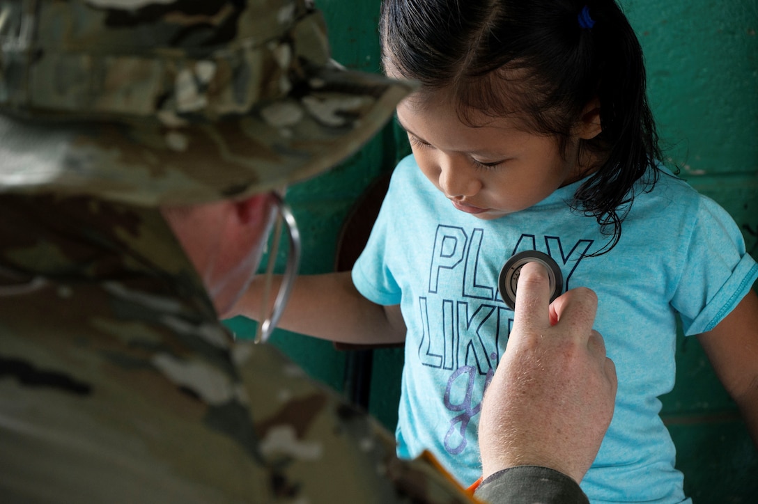 A photo of a doctor helping a child.