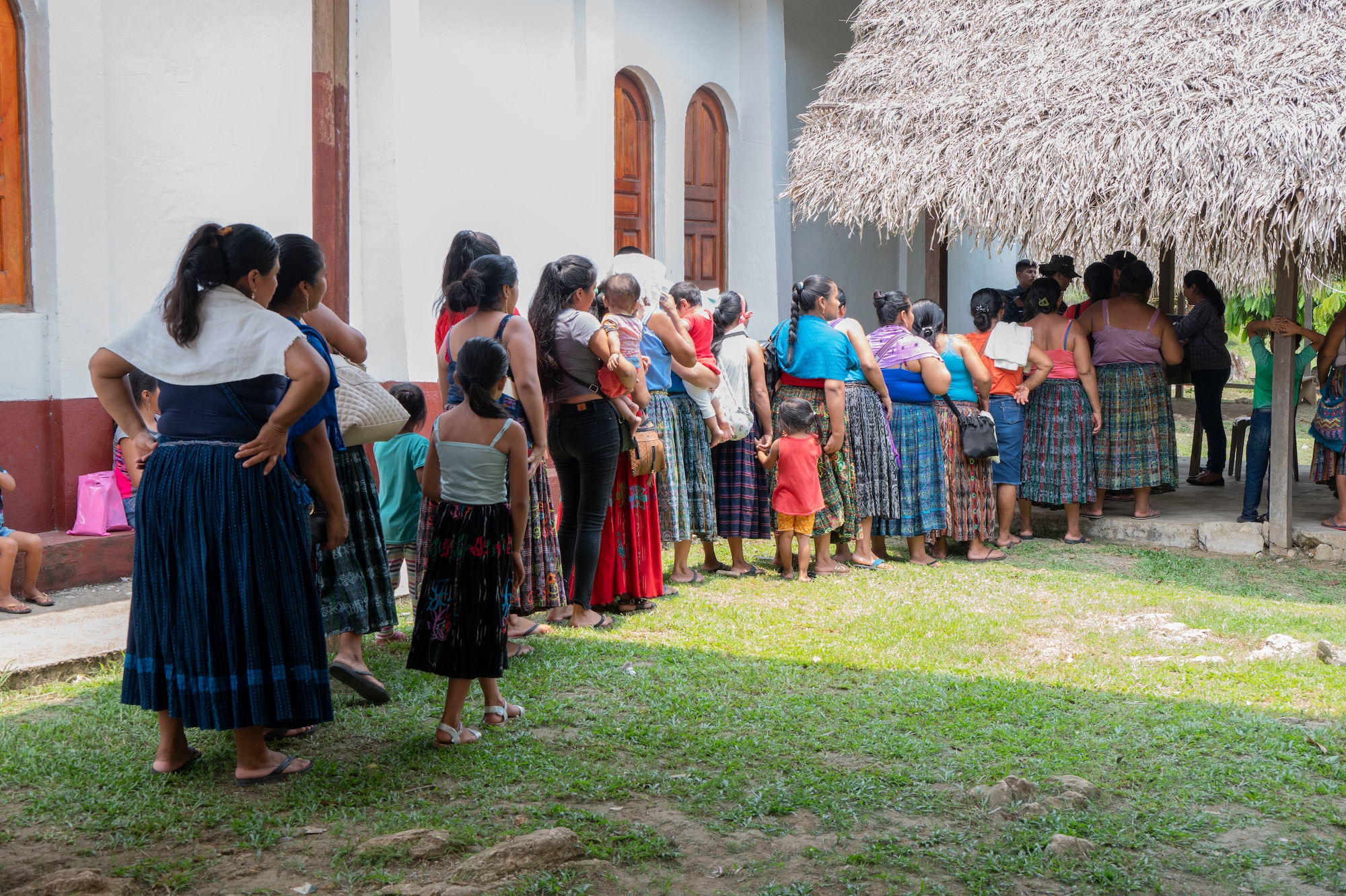A photo of women standing in line.