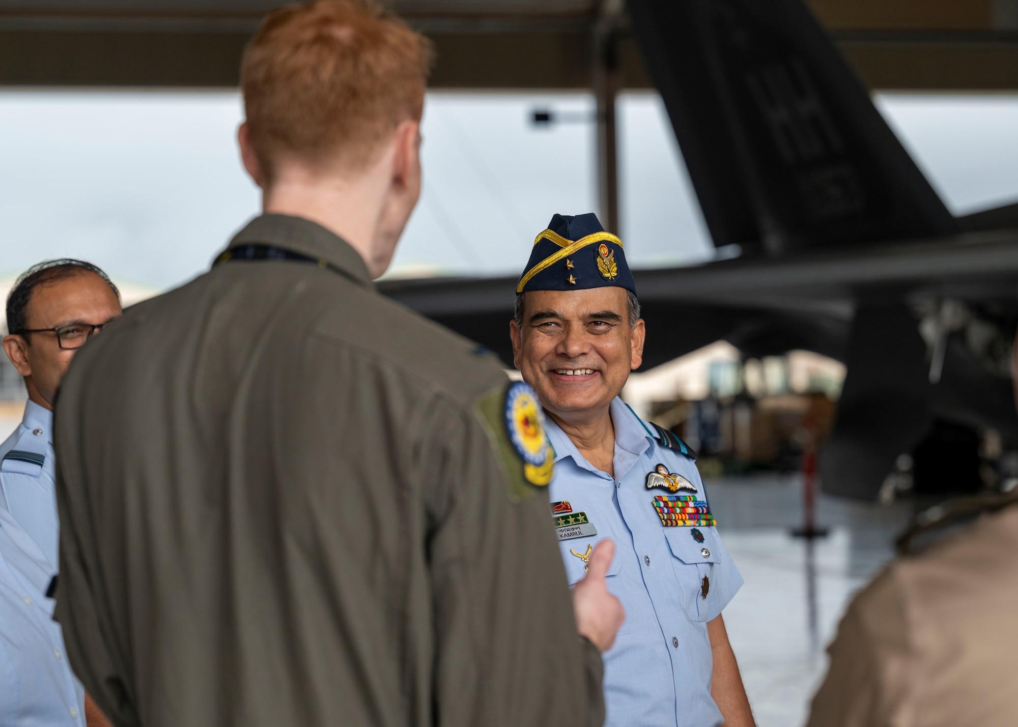 Photo of Bangladesh Air Force Air Vice Marshal speaking with a U.S. Air Force pilot