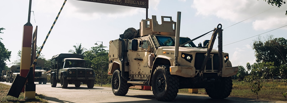 A U.S. Marine Corps Joint Light Tactical Vehicle departs Philippine Marine Base Camp Rodolfo with Philippine Marine Corps vehicles belonging to the 3rd Marine Brigade