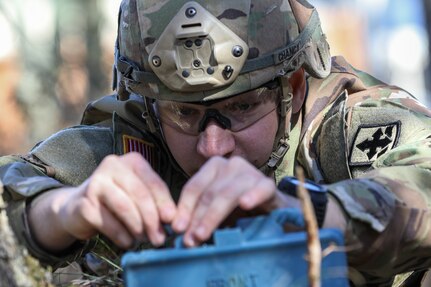 Alaska Army National Guard Pfc. Colton Cowan, an infantryman assigned to Alpha Company, 1st Battalion, 297th Infantry Regiment, places a training claymore mine during the AKARNG’s State Best Warrior Competition at Camp Carroll on Joint Base Elmendorf-Richardson, May 15, 2024.