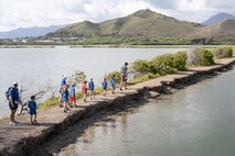 Students of Mokapu Elementary School search for different animal species during their field trip to the Nu’upia Ponds Wildlife Management Area, Marine Corps Base Hawaii, April 15, 2024. The purpose of the field trip was to educate students on the importance of stewardship over the Mokapu Peninsula and instill a sense of responsibility towards preserving the local environment. (U.S. Marine Corps photo by Lance Cpl. Clayton Baker)