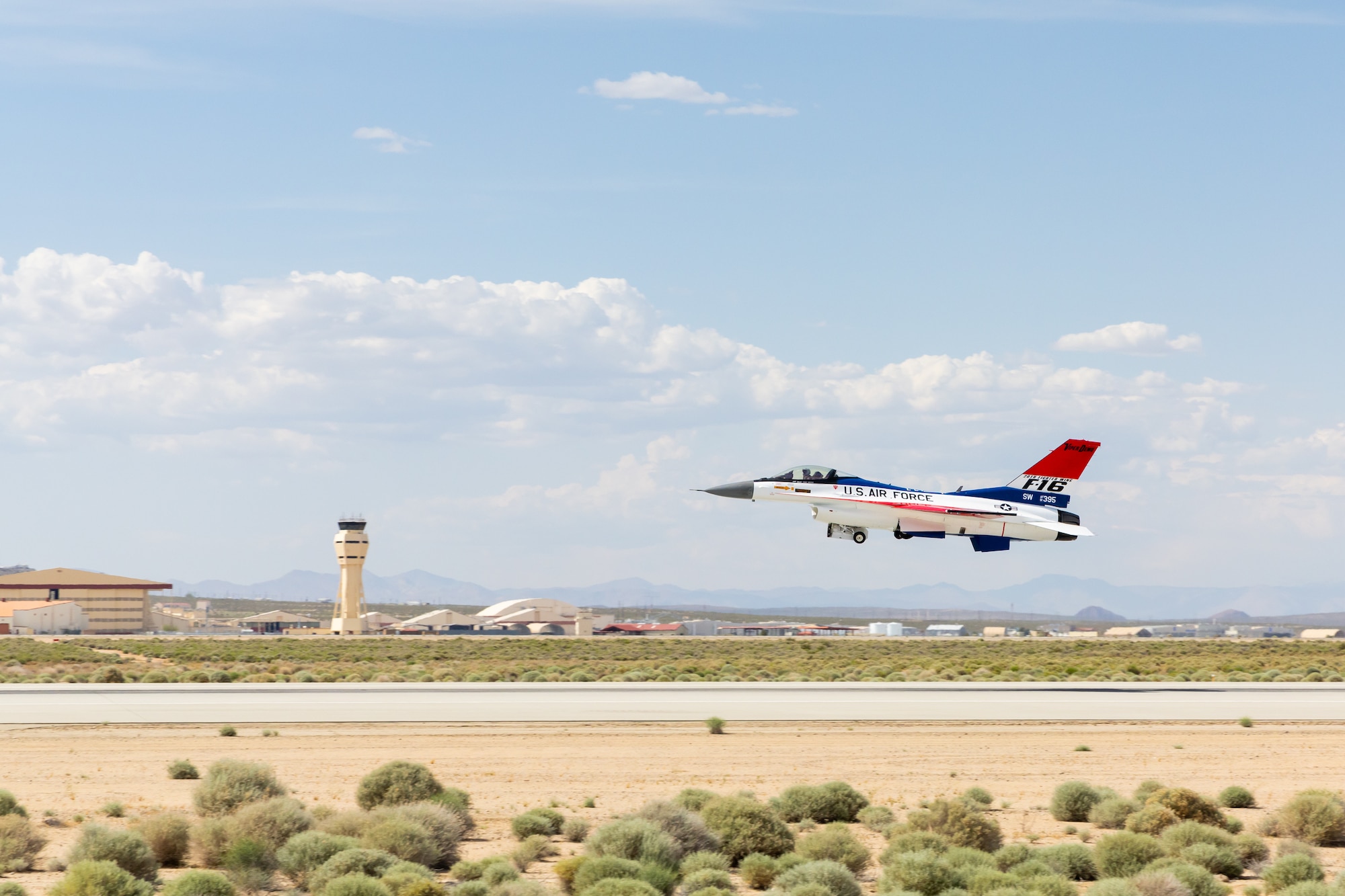 The F-16 Viper Demonstration Team jet flies above Edwards Air Force, California, May 13. The 412th Maintenance Group, Fabrication Flight - Corrosion Control Team recently repainted the F-16 Viper Demo Team aircraft in the classic YF-16 livery to commemorate the platform's first flight 50 years ago at Edwards Air Force Base, California. (Air Force photo by James West)