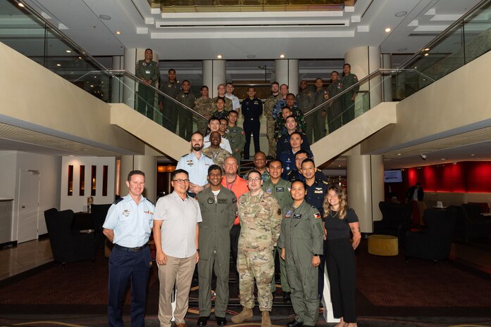 Group photo of personnel from multiple militaries attending a conference in New Zealand.
