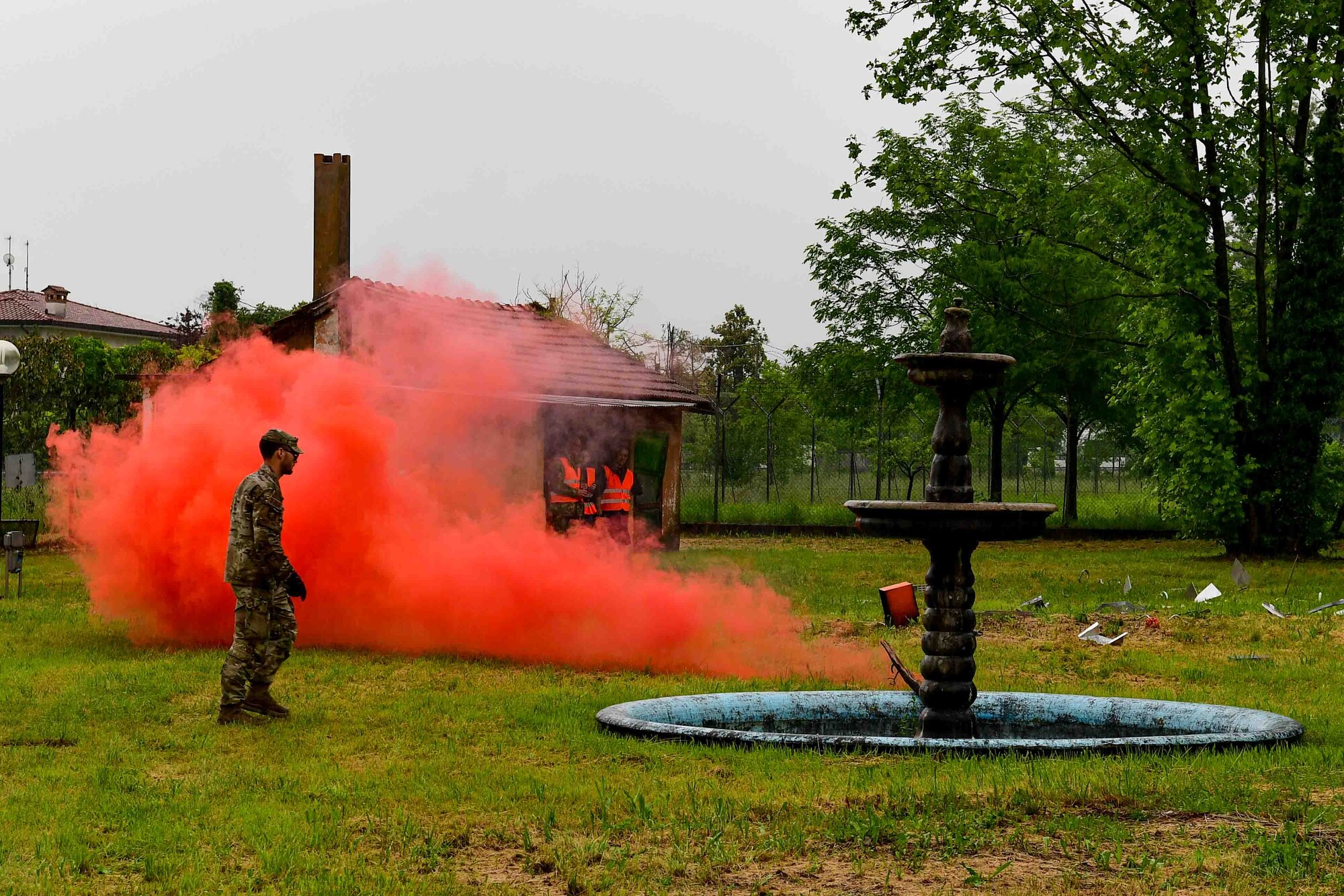 U.S. Air Force member stand by lit flare