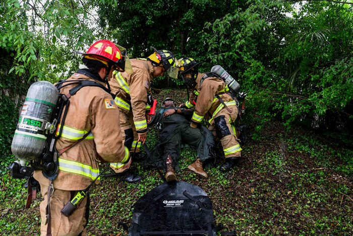 U.S. Air Force members assist a simulated patient