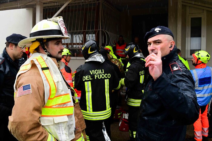 An Air Force members speaks to a local Italian authority