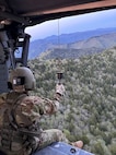 Sgt. 1st Class Cassandra Antes, a paramedic assigned to Task Force Smokey, prepares to be hoisted down to rescue an injured hiker May 20, 2024, in Great Smoky Mountains National Park.