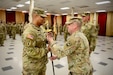 Command Sgt. Maj. John B. Ramos, incoming senior enlisted advisor of the 213th Regional Support Group, receives the noncommissioned officer sword from Col. Frank Montgomery, commander of the 213th RSG, during the "passing of the NCO sword" during a change of responsibility ceremony at Fort Indiantown Gap, Pennsylvania, May 18, 2024. The passing of the NCO sword is symbolic of the senior enlisted advisor role being passed from one NCO to another. (U.S. Army National Guard photo by Sgt. 1st Class Thomas Bixler)