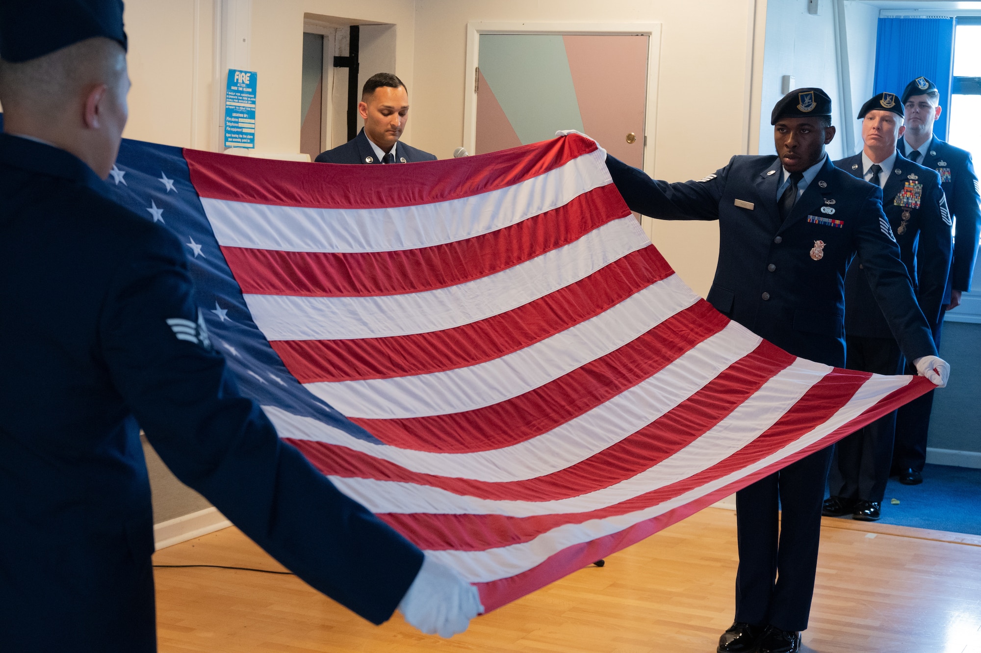 Defenders fold American flag