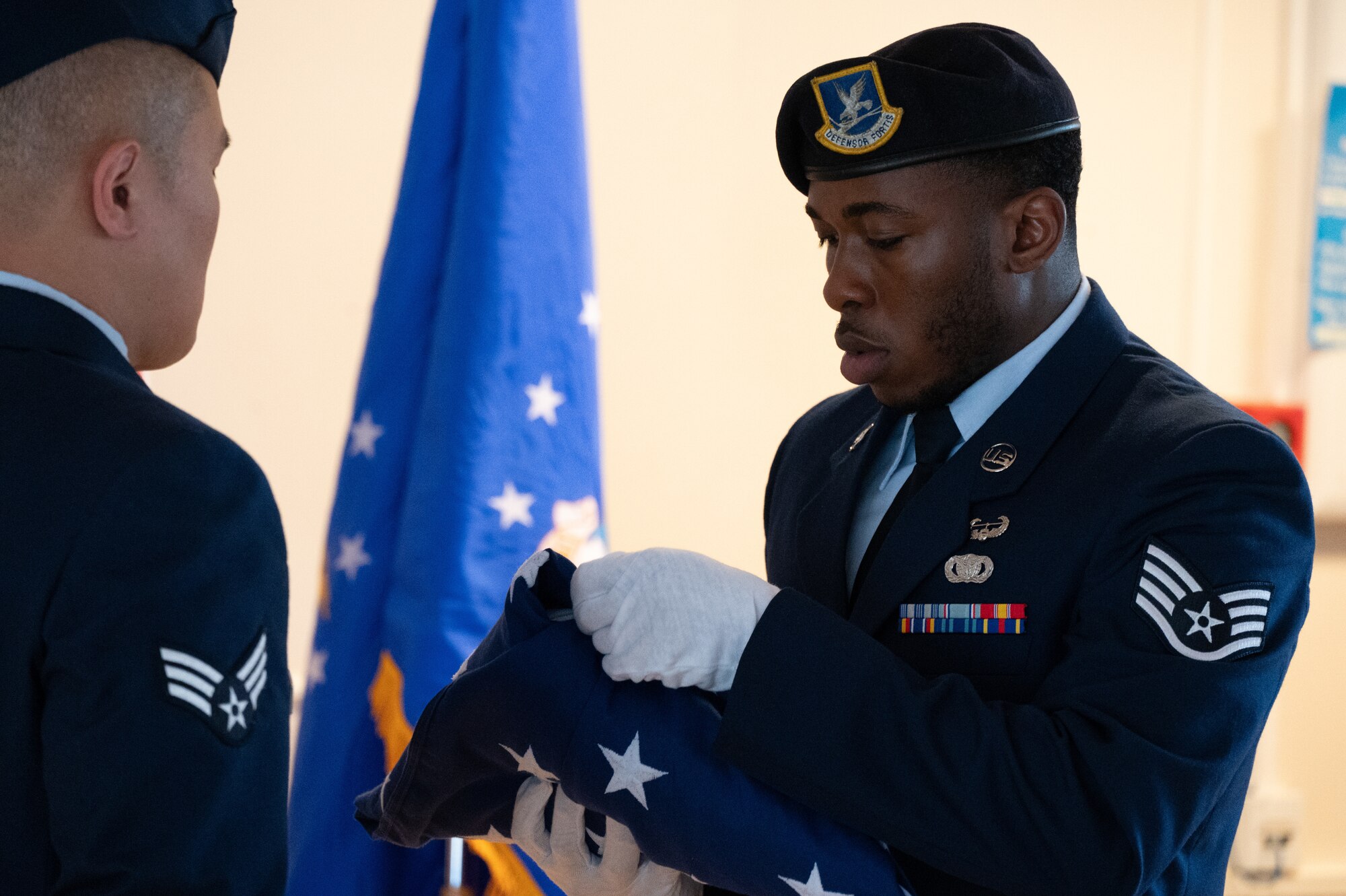 Defenders fold American flag