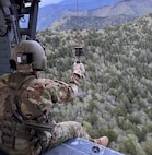 Sgt. 1st Class Cassandra Antes, a paramedic assigned to Task Force Smokey, prepares to be hoisted down to rescue an injured hiker May 20, 2024, in Great Smoky Mountains National Park.
