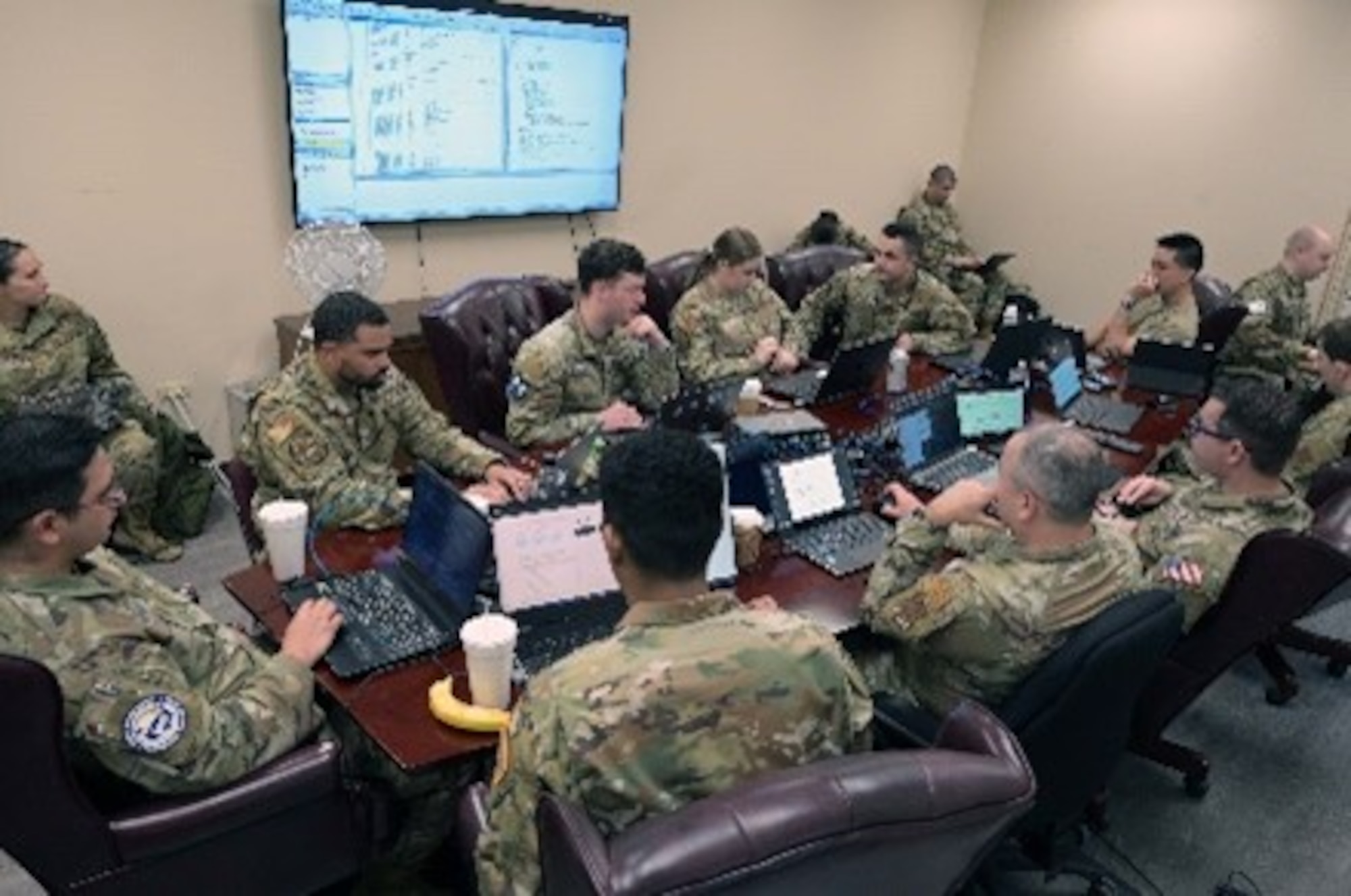 Group of Airmen sitting around a conference.