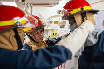 Sailors participate in a general quarters drill aboard USS Porter (DDG 78) in the Atlantic Ocean.