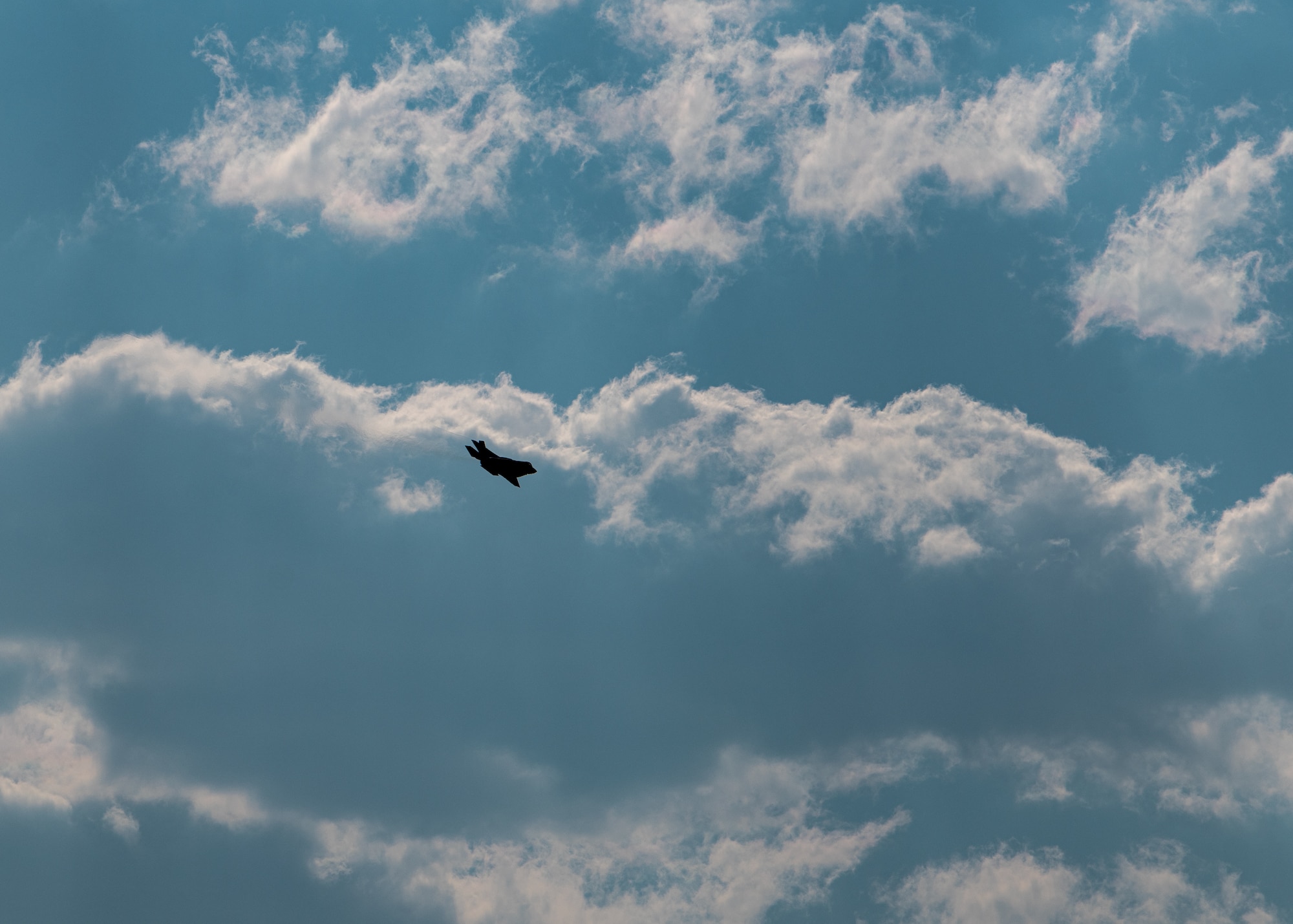 An F-35A Lightning II flies among clouds