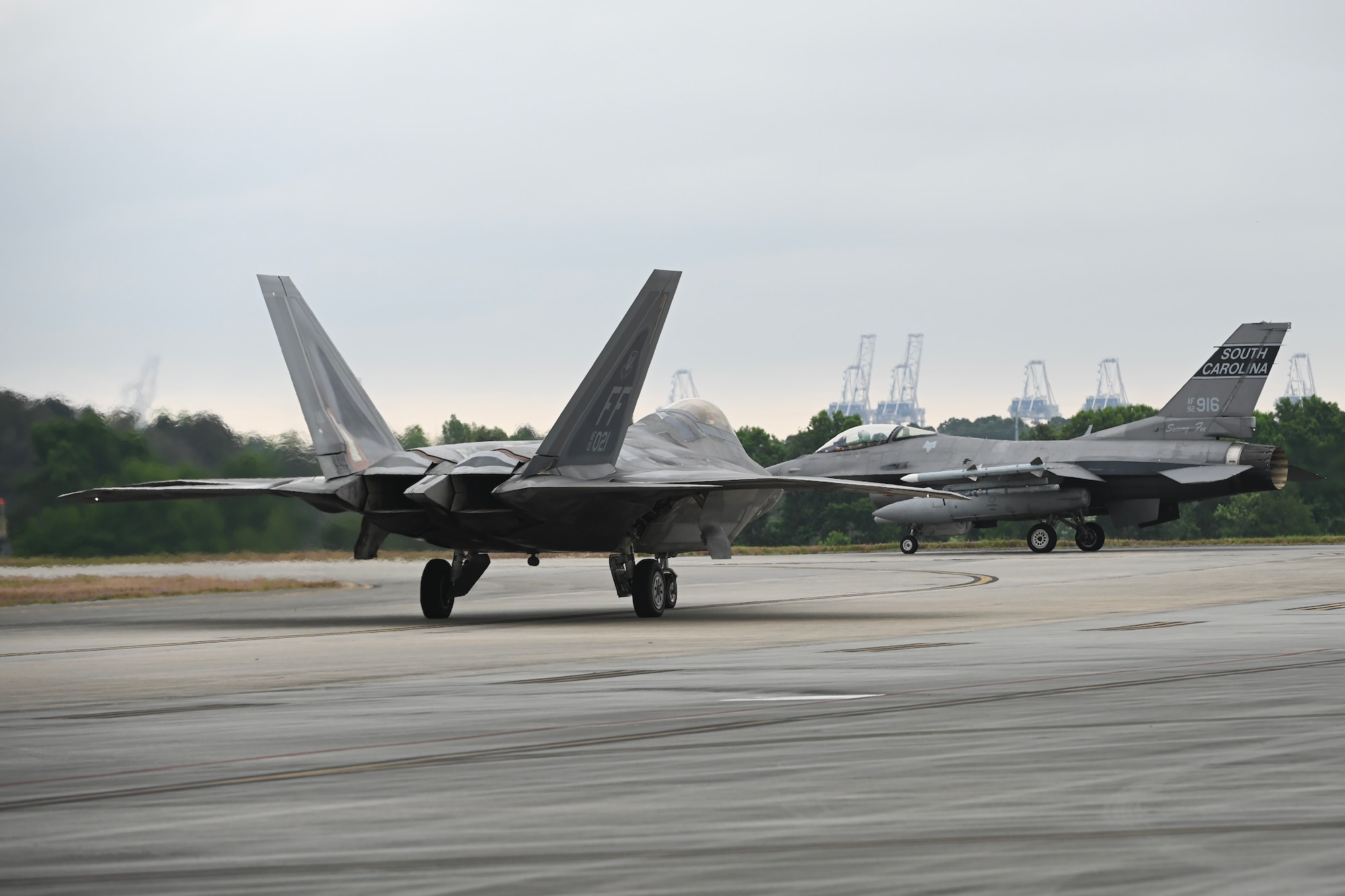 An F-16 Fighting Falcon fighter jet with the South Carolina Air National Guard’s 169th Fighter Wing and an F-22 Raptor assigned to the 1st Fighter Wing, Joint Base Langley-Eustis, Virginia, taxi during exercise Sentry Savannah hosted by the Air Dominance Center in Savannah, Georgia, May 9, 2024.