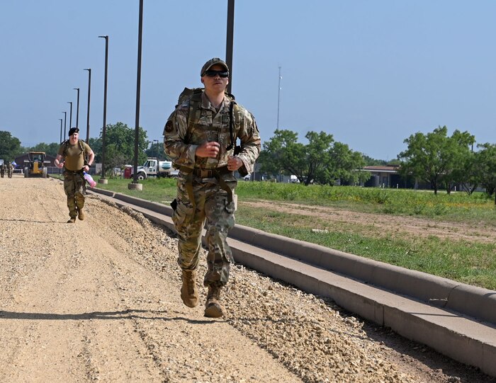 U.S. Air Force Tech. Sgt. Demarcus Haynes, 17th Security Forces Squadron operations noncommissioned officer in charge, participates in a ruck march for National Police Week at Goodfellow Air Force Base, Texas, May 13, 2024. Airmen were rucking to pay their respects to fallen law enforcement officers and symbolize carrying on their legacy. (U.S. Air Force photo by Airman 1st  Class Evelyn J. D’Errico)