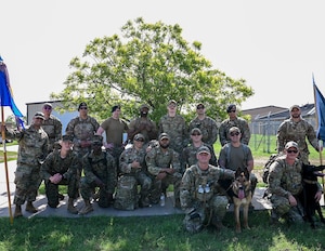 17th Security Forces Squadron defenders pose for a group photo after part in a ruck march for National Police Week at Goodfellow Air Force Base, May 13, 2024. Airmen were rucking to pay their respects to fallen law enforcement officers and symbolize carrying on their legacy. (U.S. Air Force photo by Airman 1st Class Evelyn J. D’Errico)