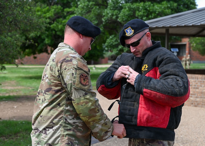 U.S. Air Force Staff Sgt. Anthony Reschka and Staff Sgt. Alan Muhle, 17th Security Forces Squadron military working dog handlers, prepare for a MWD demonstration during National Police Week at the Western Winds Dining Facility, Goodfellow Air Force Base, Texas, May 16, 2024. The events organized by the 17th SFS throughout the week aimed to not only commemorate the fallen but also foster camaraderie and teamwork among service members. (U.S. Air Force photo by Airman 1st Class Evelyn J. D’Errico)