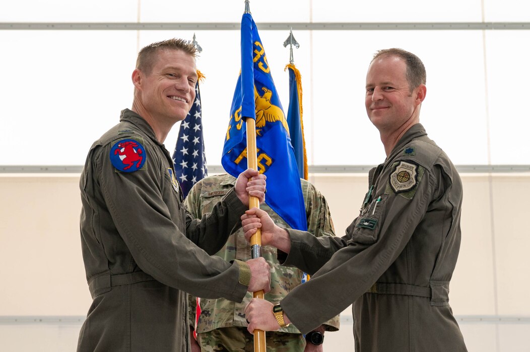 U.S. Air Force Col. Curtis Dougherty (left), 354th Operations Group commander, receives the guidon from Lt. Col. Ryan Worrell, 356th Fighter Squadron outgoing commander, during a change of command ceremony at Eielson Air Force Base, Alaska, May 17, 2024.