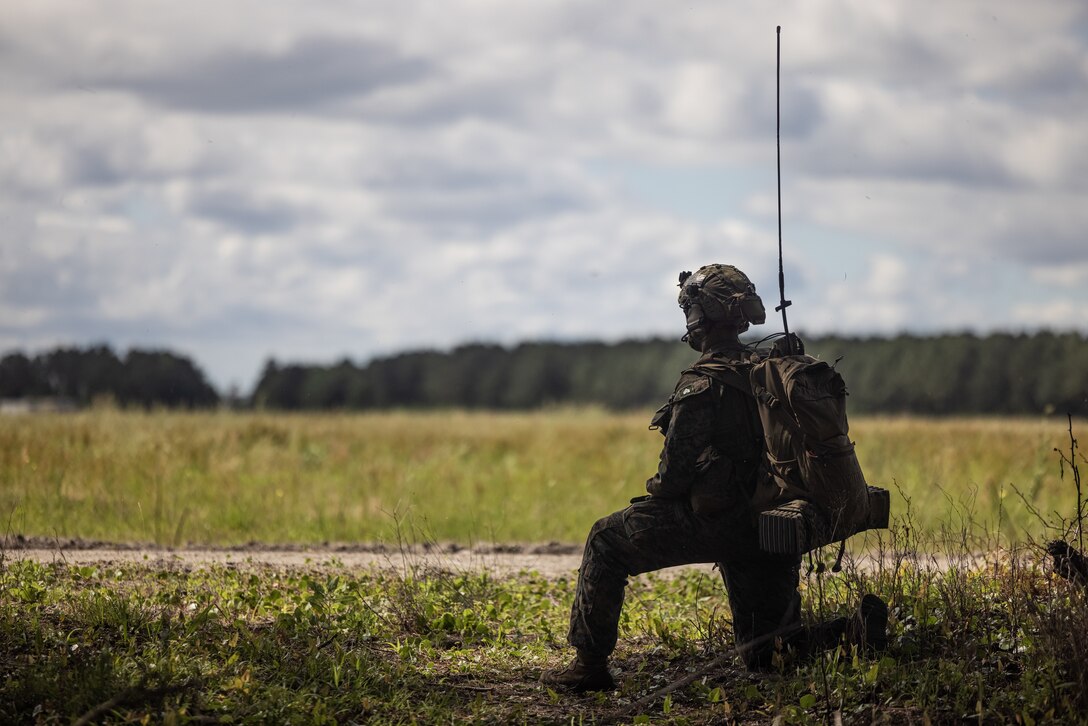 A U.S. Marine with Battalion Landing Team 1/8, 24th Marine Expeditionary Unit (MEU), communicates with aircraft during an amphibious assault mission as part of Composite Unit Training Exercise (COMPTUEX), on Camp Lejeune, North Carolina, May 11, 2024. The Wasp (WSP) Amphibious Ready Group (ARG)-24th MEU is conducting COMPTUEX, their final at-sea certification exercise under the evaluation of Carrier Strike Group 4 and Expeditionary Operations Group. Throughout COMPTUEX, the WSP ARG-24th MEU is evaluated across a spectrum of scenarios that determine their readiness to deploy. (U.S. Marine Corps photo by Lance Cpl. Ryan Ramsammy)