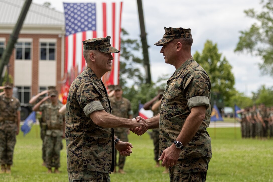 U.S. Marine Corps Maj. Gen. William H. Swan, left, from Wisconsin, and commanding general of 2nd Marine Aircraft Wing (MAW), and Maj. Gen. Scott F. Benedict, from California, and former commanding general of 2nd MAW, shake hands during a change of command ceremony at Marine Corps Air Station Cherry Point, North Carolina, May 16, 2024. The ceremony represented a transfer of responsibility, authority, and accountability from Benedict to Swan. (U.S. Marine Corps photo by Lance Cpl. Orlanys Diaz Figueroa)