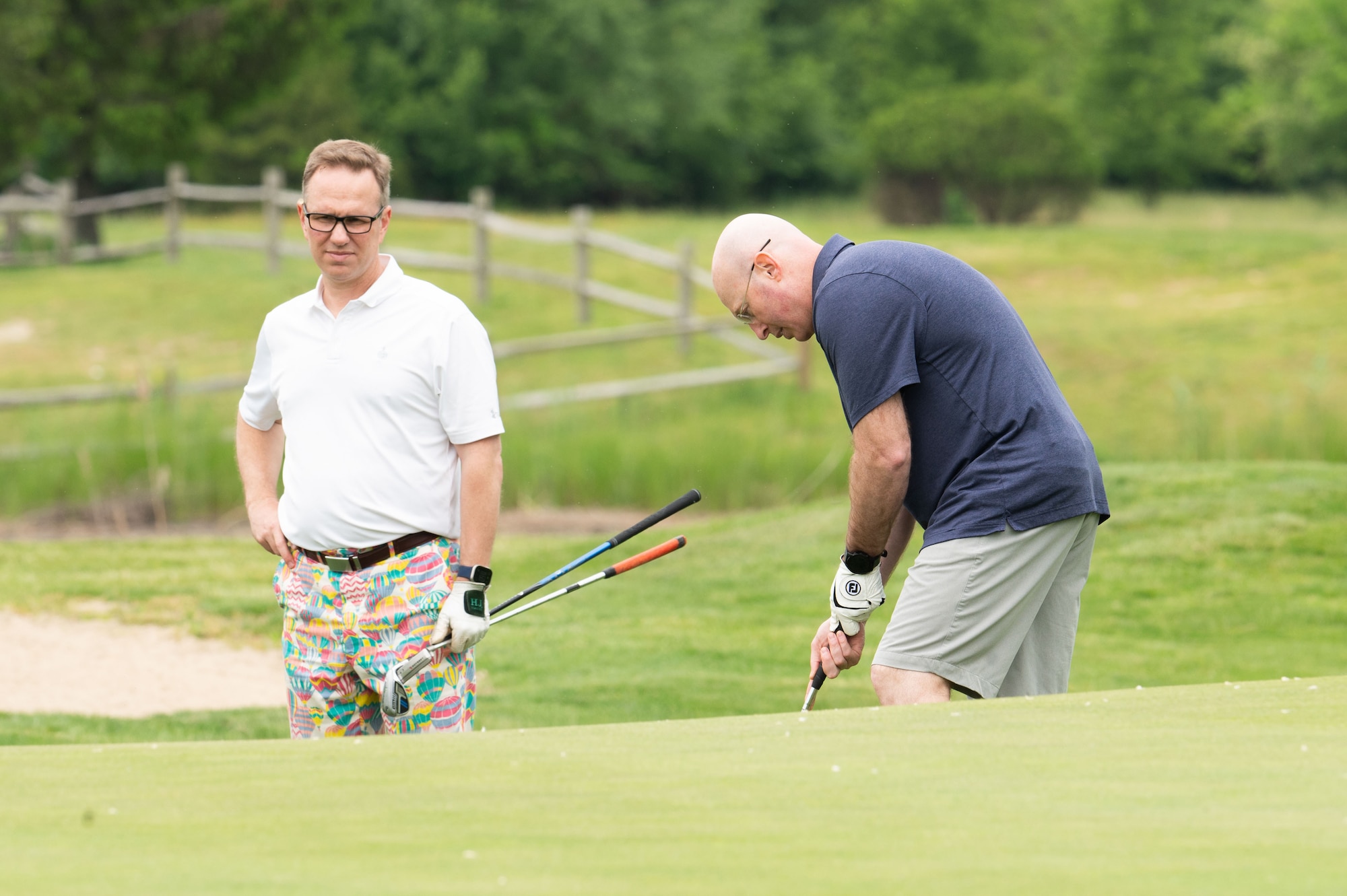 U.S. Air Force Cols. Chris McDonald, 436th Airlift Wing commander, right, and Kenneth Weiner, 436th Operations Group commander, left, participate in the Bluesuiters Golf Tournament at Jonathan’s Landing Golf Course in Magnolia, Delaware, May 9, 2024. At the event, Team Dover Airmen were sponsored by local civic and business leaders so that they could play in the tournament. (U.S. Air Force photo by Airman Liberty Matthews)