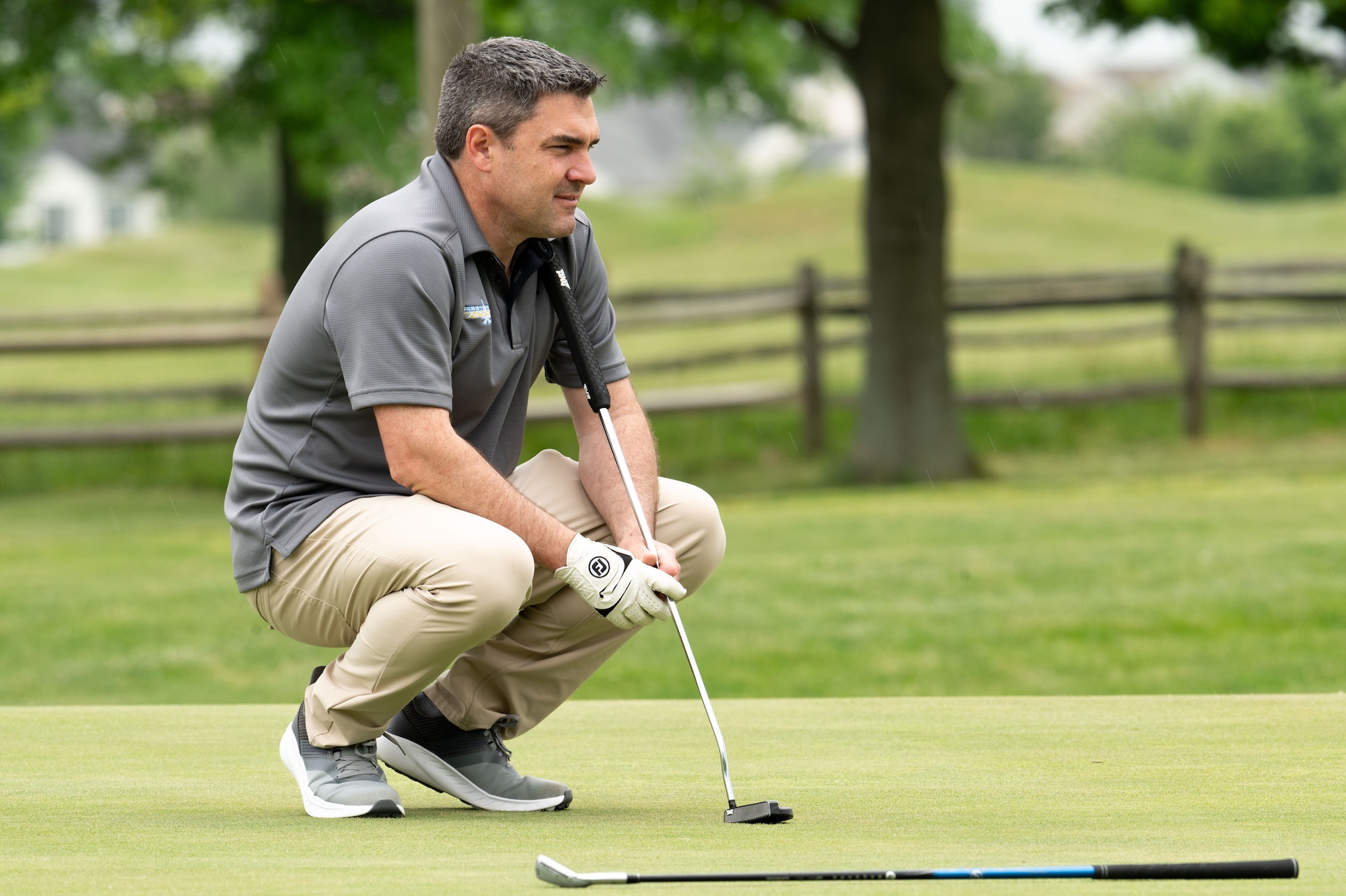 U.S. Air Force Col. Rusty Gohn, 436th Airlift Wing deputy commander, studies the green at the Bluesuiters Golf Tournament at Jonathan’s Landing Golf Course in Magnolia, Delaware, May 9, 2024. At the event, Team Dover Airmen were sponsored by local civic and business leaders so that they could play in the tournament. (U.S. Air Force photo by Airman Liberty Matthews)