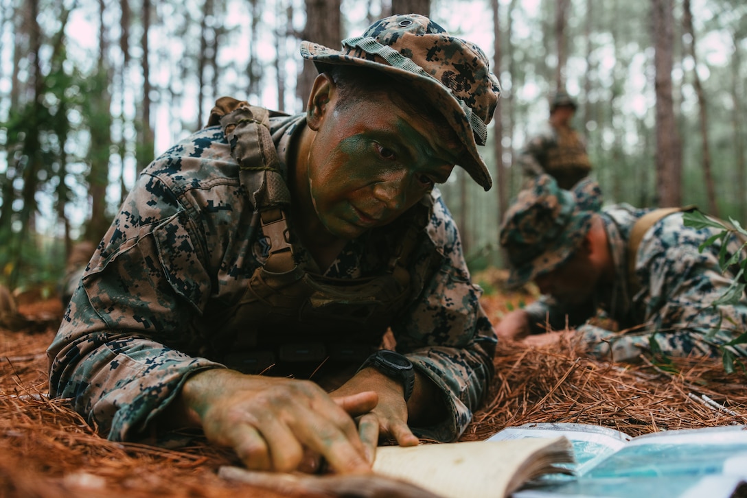 U.S. Marine Corps Sgt. Andrew Redeyerozler, a Salamanca, New York native and a squad leader with 2d Battalion, 2d Marine Regiment, 2d Marine Division, plots coordinates during the Division Signals and Emissions Course (DSEC) on Camp Lejeune, North Carolina, May 21, 2024. Division Training Company held DSEC in order to increase proficiency and understanding of light infantry operations in a contested and communications degraded environment. (U.S. Marine Corps photo by Cpl. Alexis Sanchez)