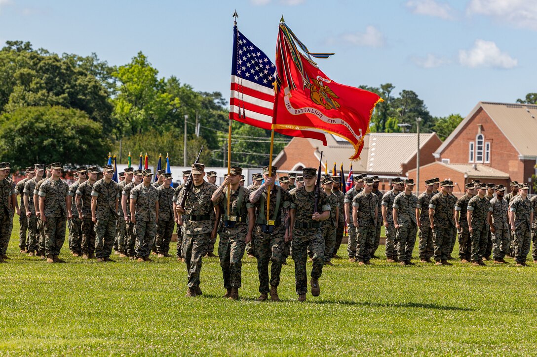 U.S. Marines with Battalion Landing Team 1/6, 26th Marine Expeditionary Unit (Special Operations Capable), carry the battalion colors during a change of command ceremony on Marine Corps Base Camp Lejeune, North Carolina, May 16, 2024. A change of command ceremony signifies the transfer of responsibility, authority and accountability from the outgoing commanding officer to the oncoming commanding officer. (U.S. Marine Corps photo by Cpl. Rafael Brambila-Pelayo)
