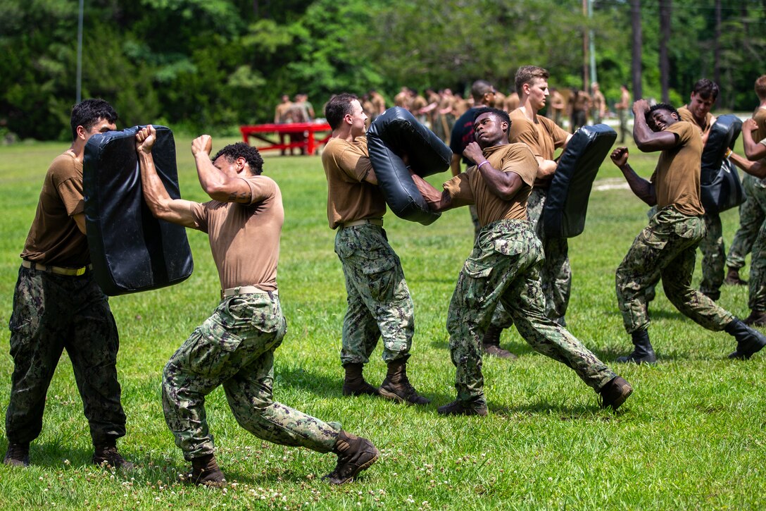 U.S. Naval Academy Midshipmen, perform punching techniques as part of Marine Corps Martial Arts Program (MCMAP) training, during a Career Orientation Training for Midshipmen (CORTRAMID) on Camp Lejeune, North Carolina, May 18, 2024. The CORTRAMID program is a basic introduction and training event to familiarize U.S. Naval Academy Midshipmen with the primary warfare designators that they will serve in, along with providing them with exposure to what is often their first Marine Corps fleet experience. (U.S. Marine Corps photos by Lance Cpl. Christian Salazar)