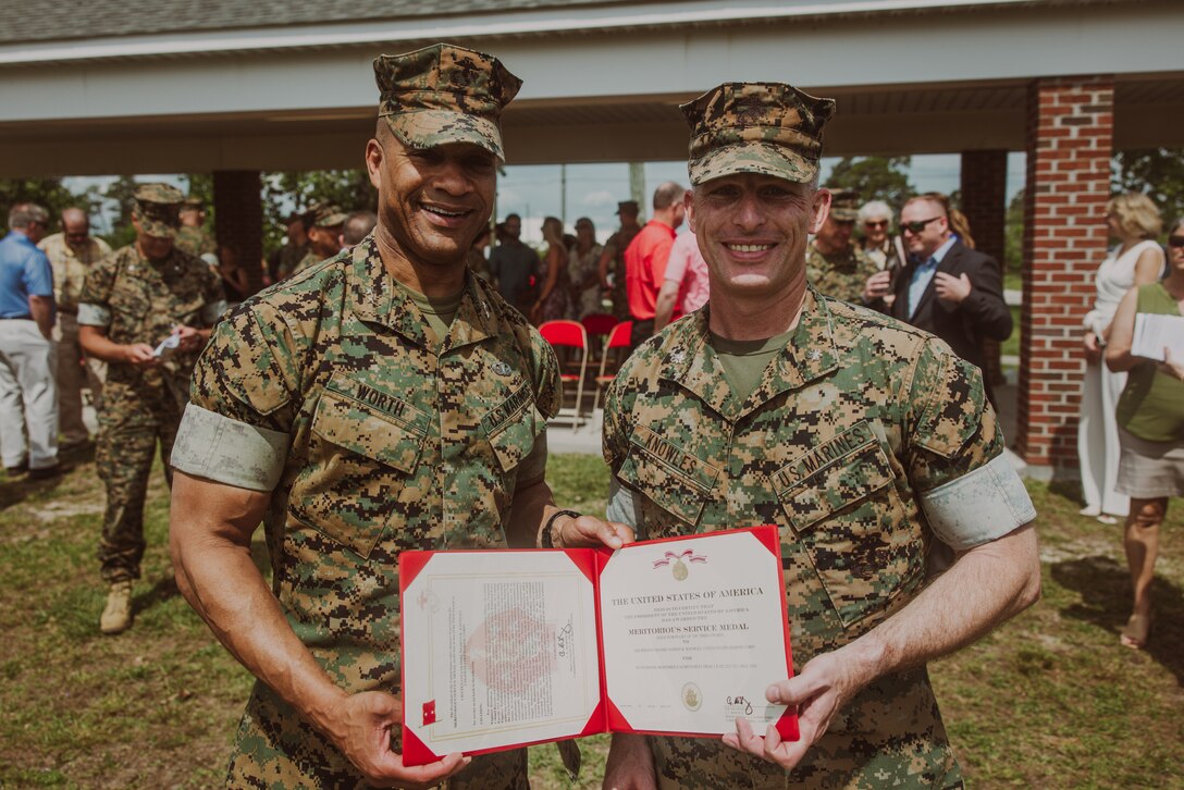 U.S. Marine Corps Maj. Gen. Calvert Worth Jr., left, the commanding general of 2d Marine Division (MARDIV), and Lt. Col. Nathan Knowles, right, the outgoing commanding officer for 2d Combat Engineer Battalion (CEB), 2d MARDIV, pose for a photo following an award ceremony on Camp Lejeune, North Carolina May 17, 2024. Knowles was awarded the meritorious service medal for his outstanding achievements as the commanding officer of 2d CEB. (United States Marine Corps photo by Pfc. Micah Thompson)
