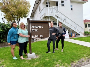 Cindi stands with volunteers outside the Airman's Attic on Fort MacArthur.