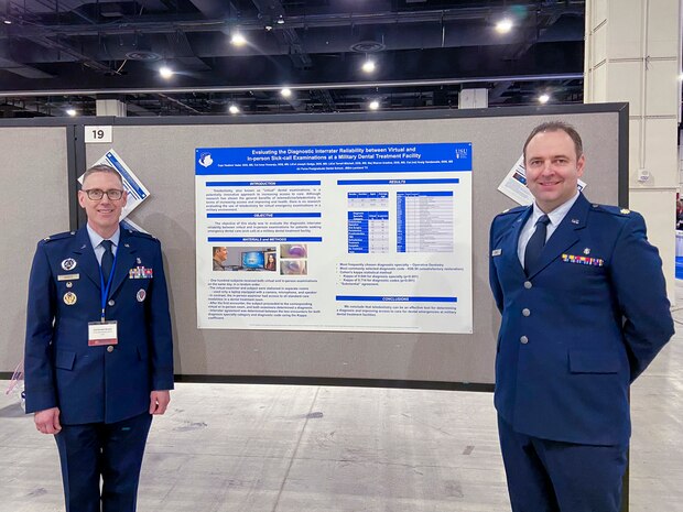 U.S. Air Force Maj. Vladimir Vader, 9th Medical Group dental flight comprehensive dentist, poses with Col. Donald W. Sheets Jr., Defense Health Agency dental clinical management team chief dental officer, as Vader presents dental research at the Defense Health Agency Research and Engineering Directorate, Clinical Investigations Program Branch poster presentation contest for early career health professionals during the meeting of The Society of Federal Health Professionals (AMSUS), Feb. 12-15, 2024 in National Harbor, Maryland.
