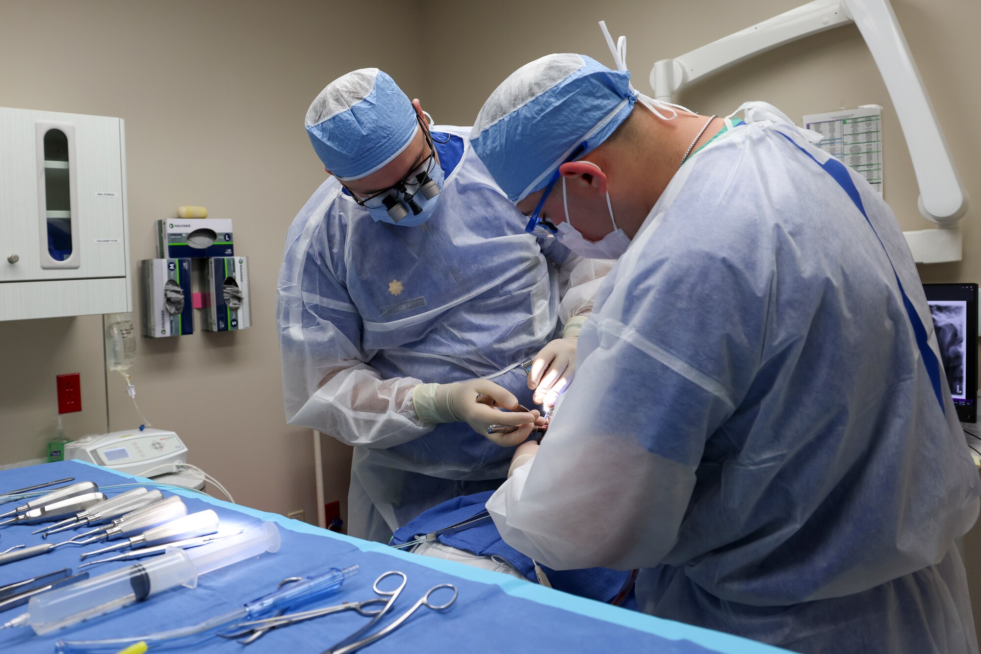 U.S. Air Force Maj. Vladimir Vader, 9th Medical Group dental flight comprehensive dentist, and Senior Airman Hunter Webster, 9th MDG dental flight dental assistant, perform wisdom teeth extraction operations on a patient at Beale Air Force Base, California, March 27, 2024.