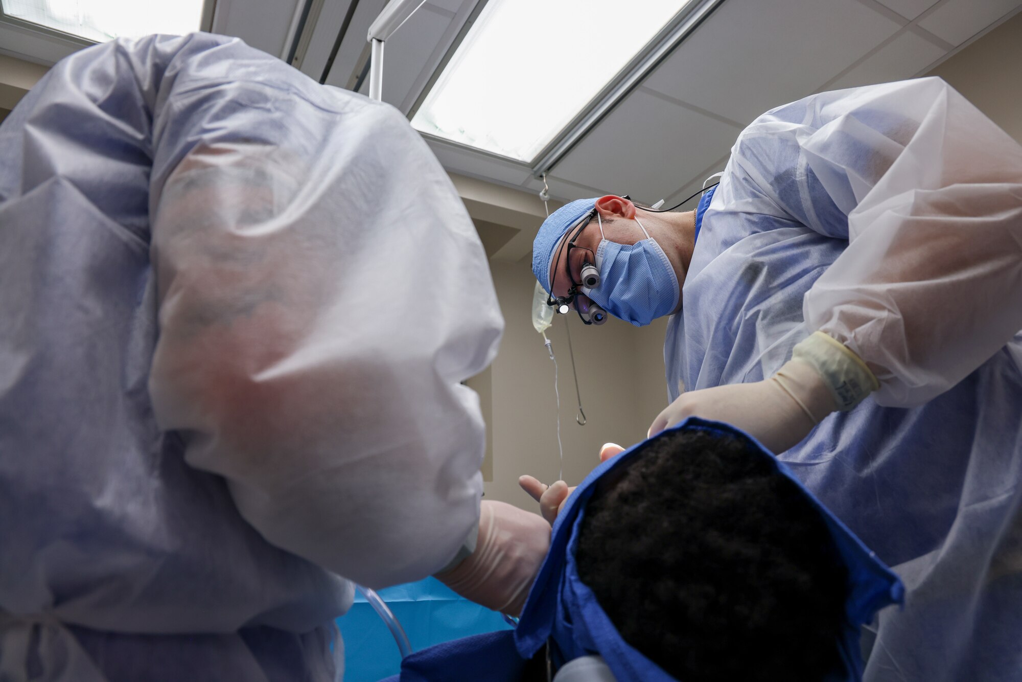 U.S. Air Force Maj. Vladimir Vader, 9th Medical Group Dental Flight comprehensive dentist, and Senior Airman Hunter Webster, 9th MDG dental flight dental assistant, perform wisdom teeth extraction operations on a patient at Beale Air Force Base, California, March 27, 2024.