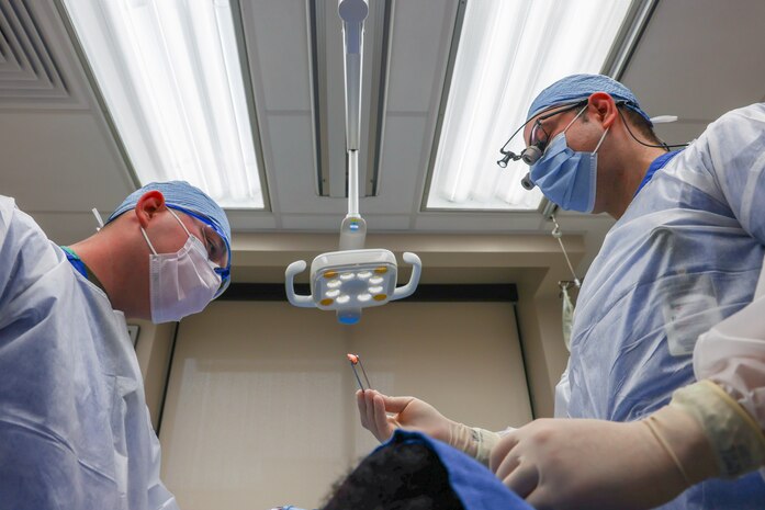 U.S. Air Force Maj. Vladimir Vader, 9th Medical Group dental flight comprehensive dentist, and Senior Airman Hunter Webster, 9th MDG dental flight dental assistant, perform wisdom teeth extraction operations on a patient at Beale Air Force Base, California, March 27, 2024.