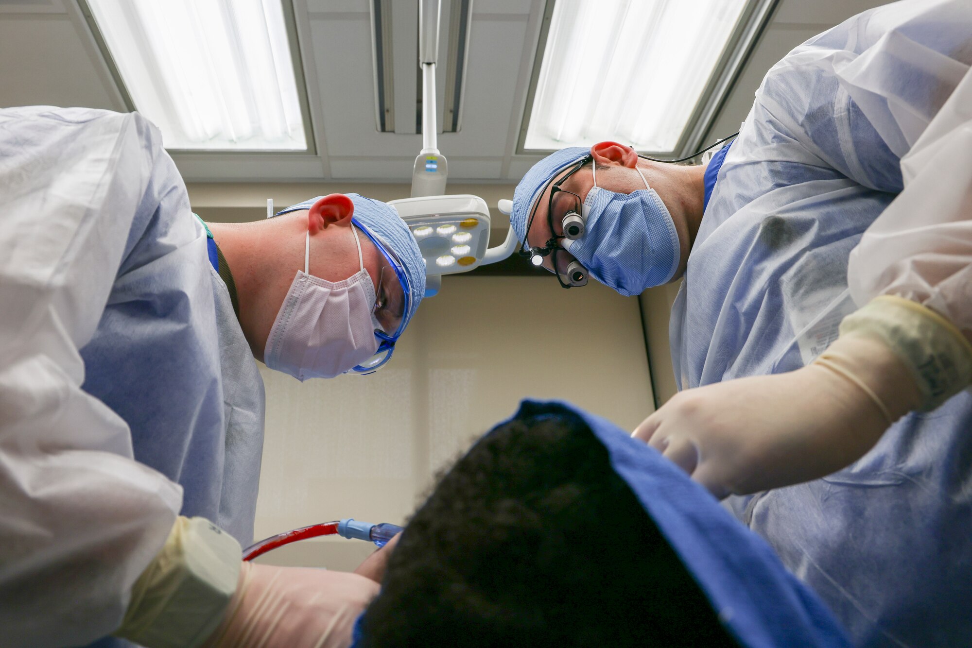 U.S. Air Force Maj. Vladimir Vader, 9th Medical Group Dental Flight comprehensive dentist, and Senior Airman Hunter Webster, 9th MDG Dental Flight dental assistant, perform wisdom teeth extraction operations on a patient at Beale Air Force Base, California, March 27, 2024.
