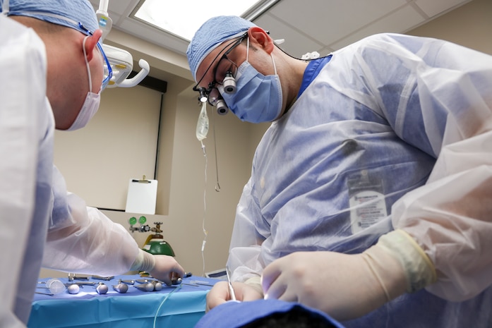 U.S. Air Force Maj. Vladimir Vader, 9th Medical Group dental flight comprehensive dentist, and Senior Airman Hunter Webster, 9th MDG dental flight dental assistant, perform wisdom teeth extraction operations on a patient at Beale Air Force Base, March 27, 2024.