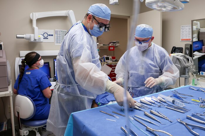 U.S. Air Force Maj. Vladimir Vader, 9th Medical Group dental flight comprehensive dentist, and Senior Airman Hunter Webster, 9th MDG Flight dental assistant, perform wisdom teeth extraction operations on a patient while Senior Airman Timber Best, 9th MDG dental flight dental assistant, monitors the patient’s sedation at Beale Air Force Base, California, March 27, 2024.