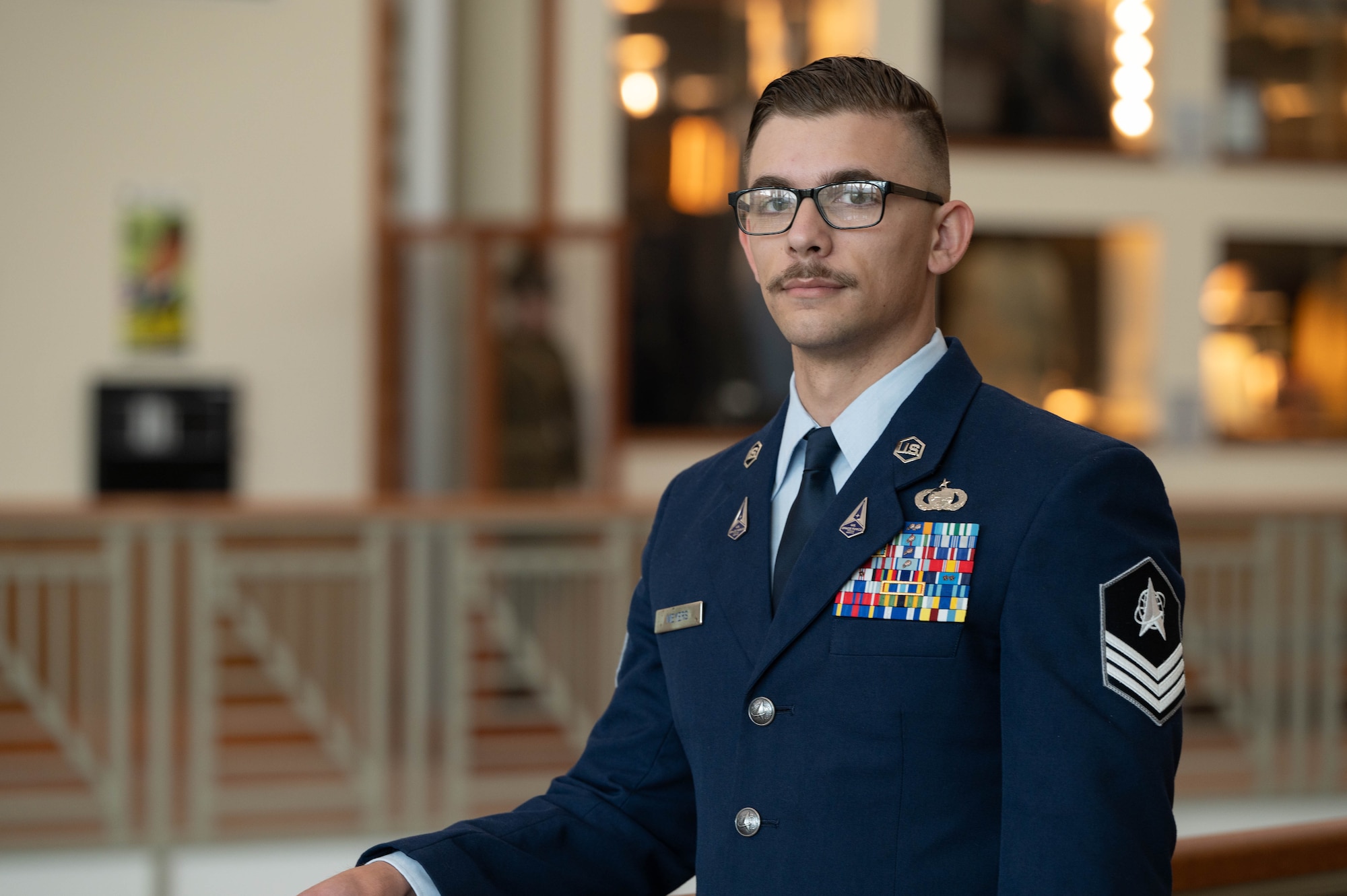 U.S. Space Force Sgt. Hunter Meyers is posing for a photo in the school house located at Fort Carson, Colorado.