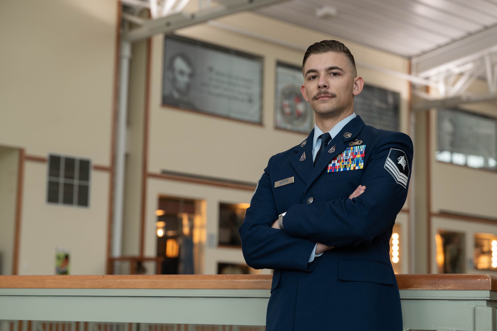 U.S. Space Force Sgt. Hunter Meyers is posing for a photo in the school house located at Fort Carson, Colorado.