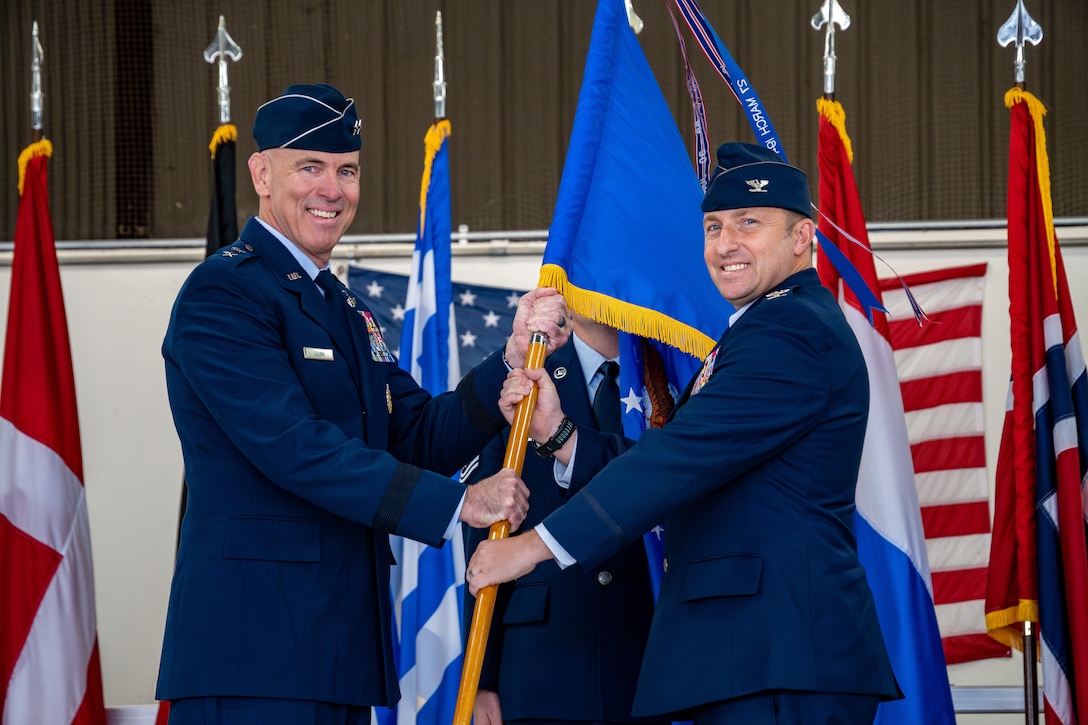 Two Air Force officers hold a guidon
