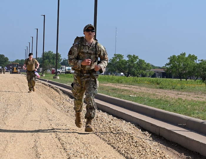 U.S. Air Force Tech. Sgt. Demarcus Haynes, 17th Security Forces Squadron operations noncommissioned officer in charge, participates in a ruck march for National Police Week at Goodfellow Air Force Base, Texas, May 13, 2024. Airmen were rucking to pay their respects to fallen law enforcement officers and symbolize carrying on their legacy. (U.S. Air Force photo by Airman 1st  Class Evelyn J. D’Errico)
