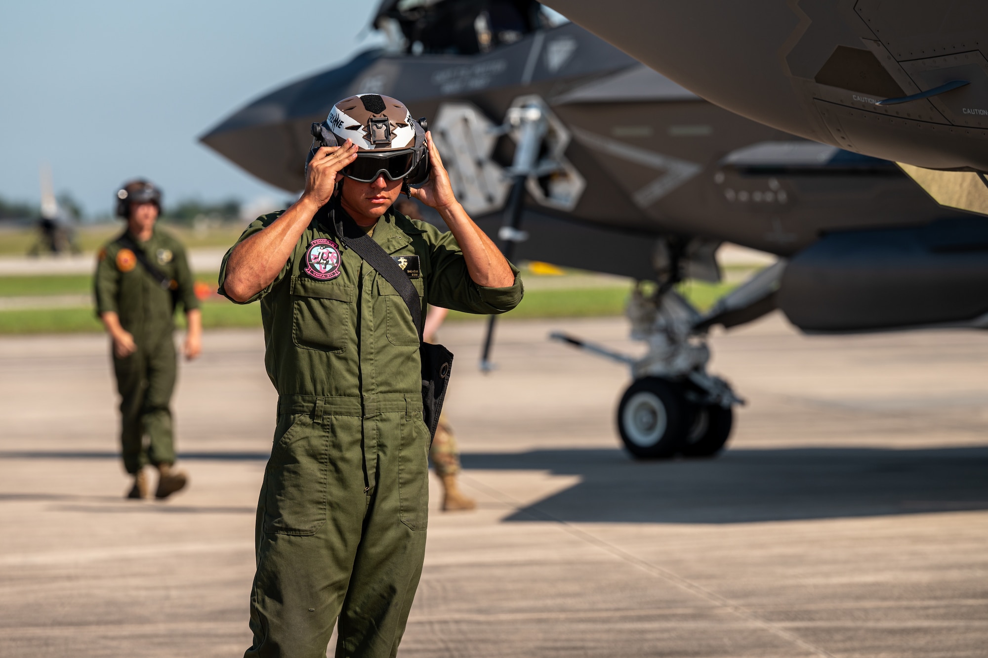 A Marine adjusts his goggles
