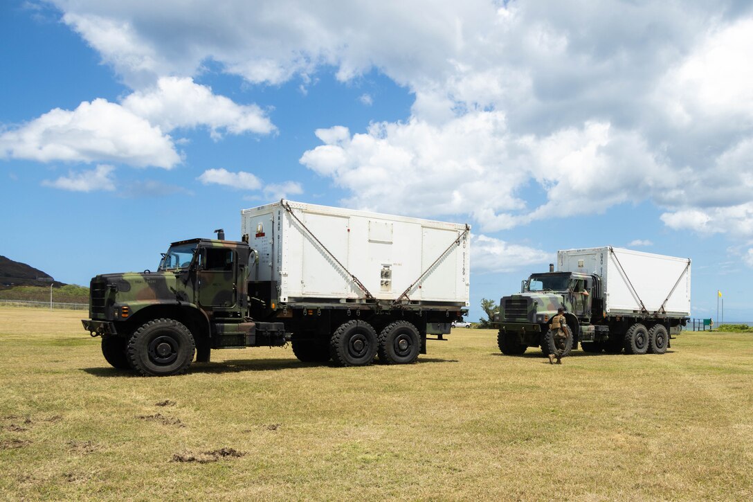 U.S. Marines with Marine Aviation Logistics Squadron (MALS) 24, Marine Aircraft Group 24,1st Marine Aircraft Wing, stage mobile maintenance facilities (MMFs) at Marine Corps Base Hawaii, April 15, 2024. The purpose of MALS-24's Displaced Warrior exercise is to demonstrate their ability to set up MMFs, assist flight operations and deliver supply support in an austere environment. (U.S. Marine Corps photo by Lance Cpl. Tania Guerrero)