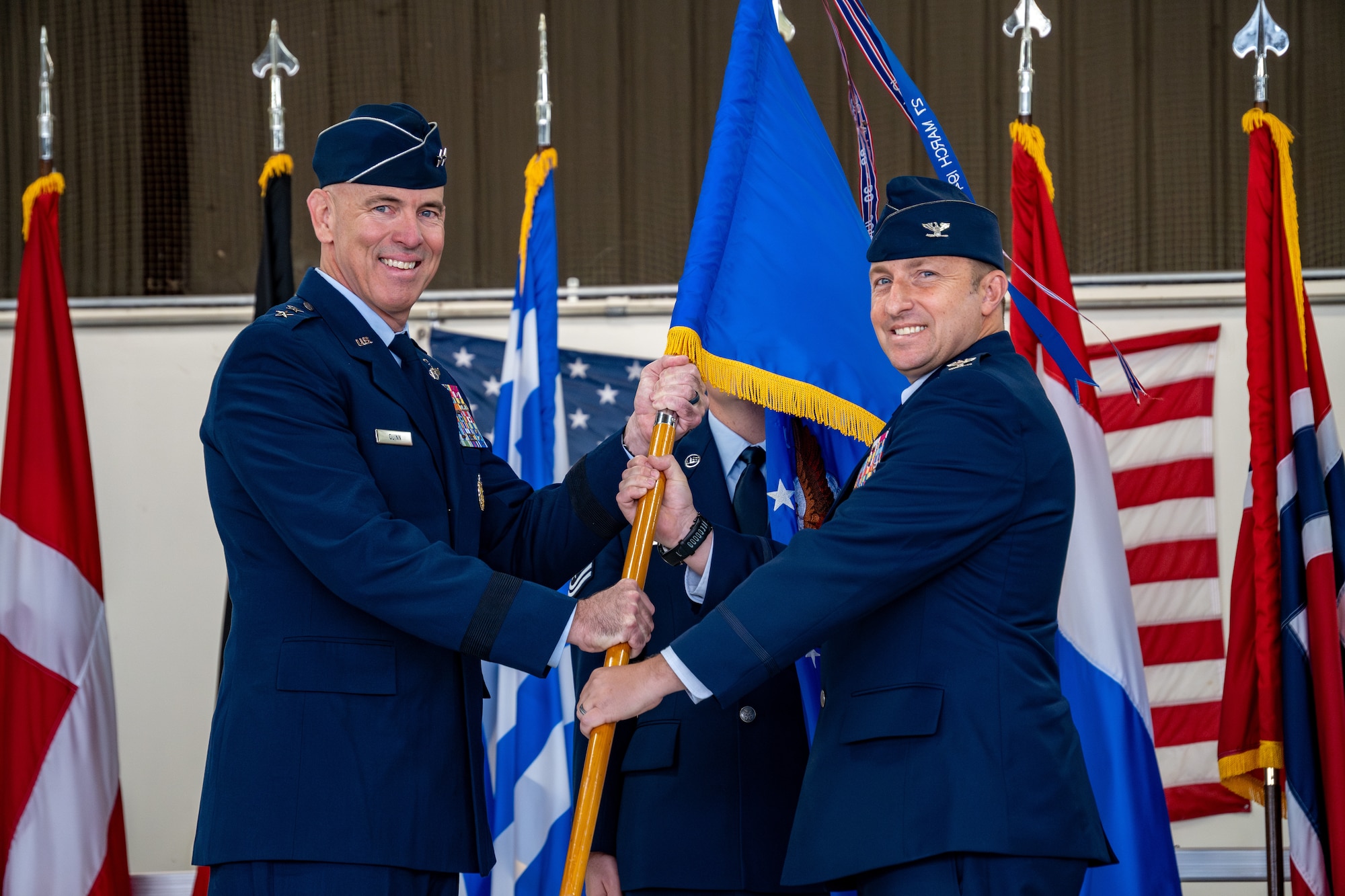 Two Air Force officers hold a guidon