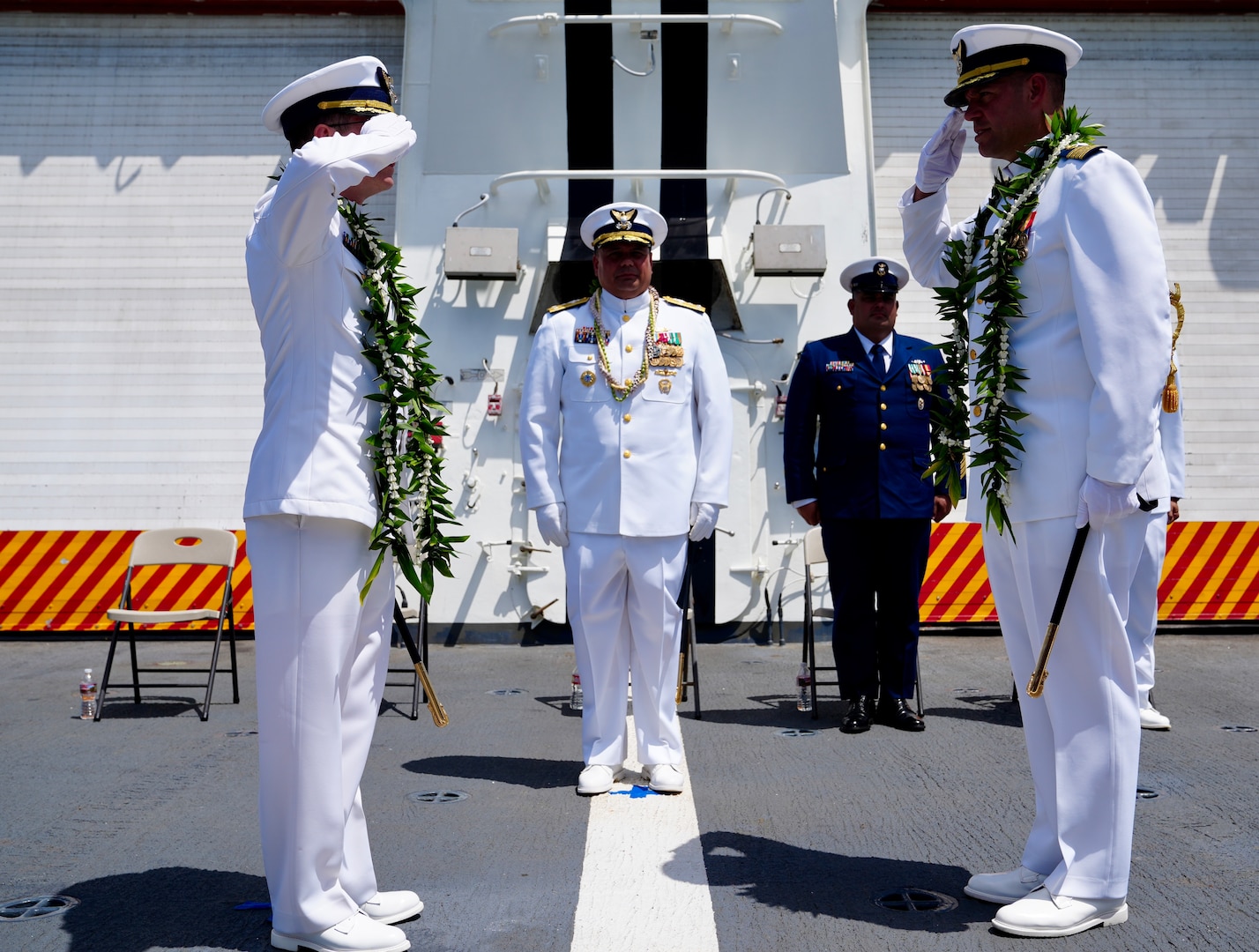 U.S. Coast Guard Capt. Tyson Scofield (left) and U.S. Coast Guard Capt. Robert Mohr (right) salute each another during the Coast Guard Cutter Waesche’s (WMSL 751) change of command ceremony aboard the cutter while moored at Base Honolulu, May 20, 2024. The change of command ceremony is a time-honored tradition representing the formal transfer of authority, responsibility, and accountability for a unit from one commanding officer to another. (U.S. Coast Guard photo by Petty Officer 3rd Class Jennifer Nilson)